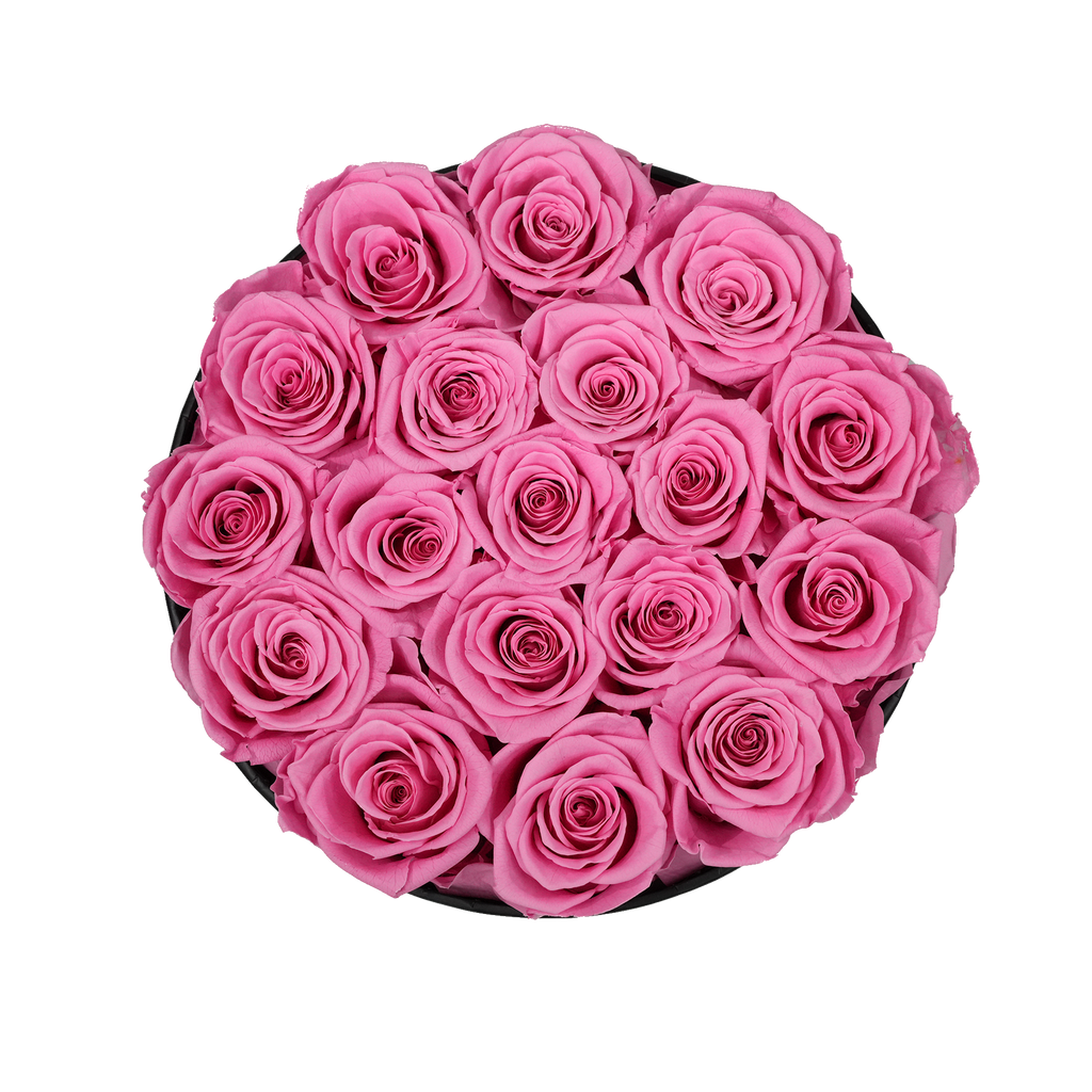 Large Round Black Box Pink Forever Roses flat lay overhead view.