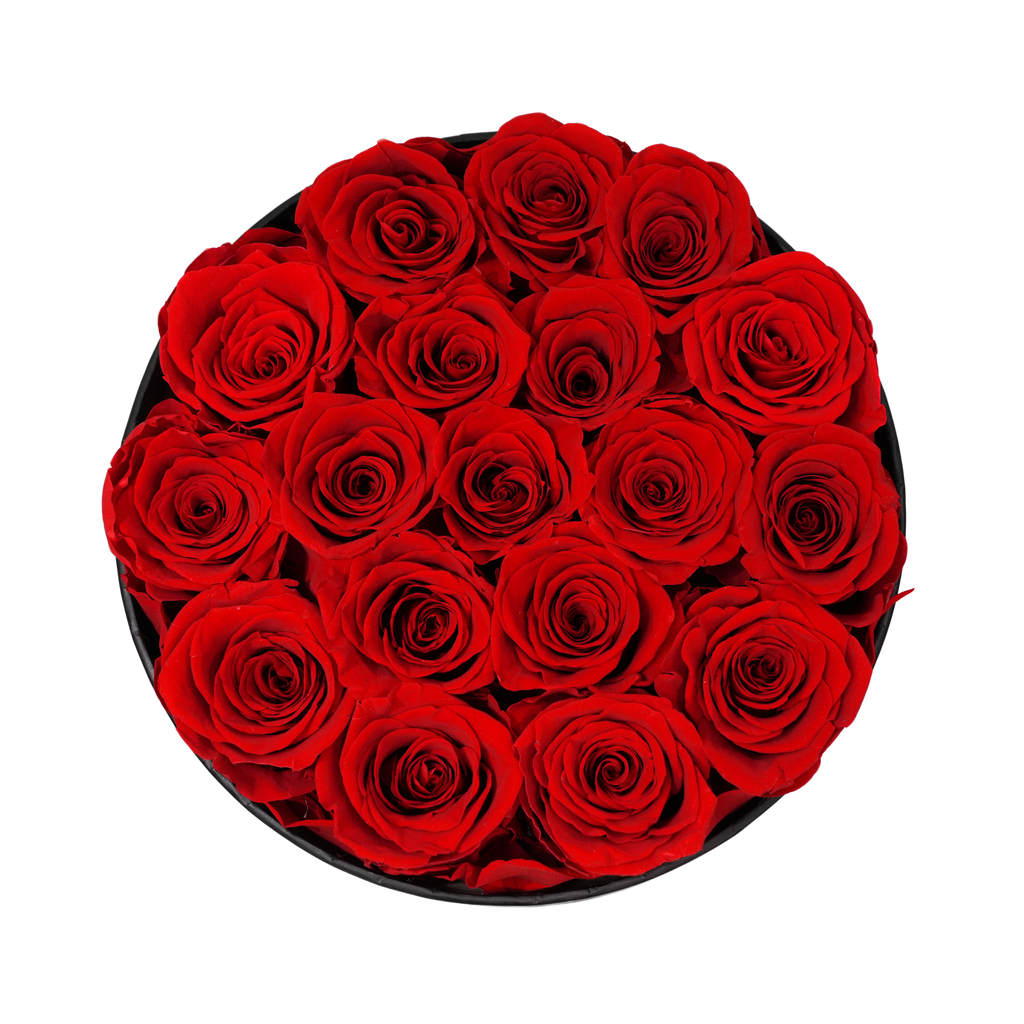 Large Round Black Box Red Forever Roses flat lay overhead view.