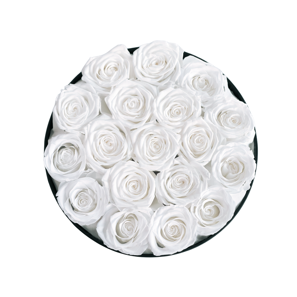 Large Round Black Box White Forever Roses flat lay overhead view.